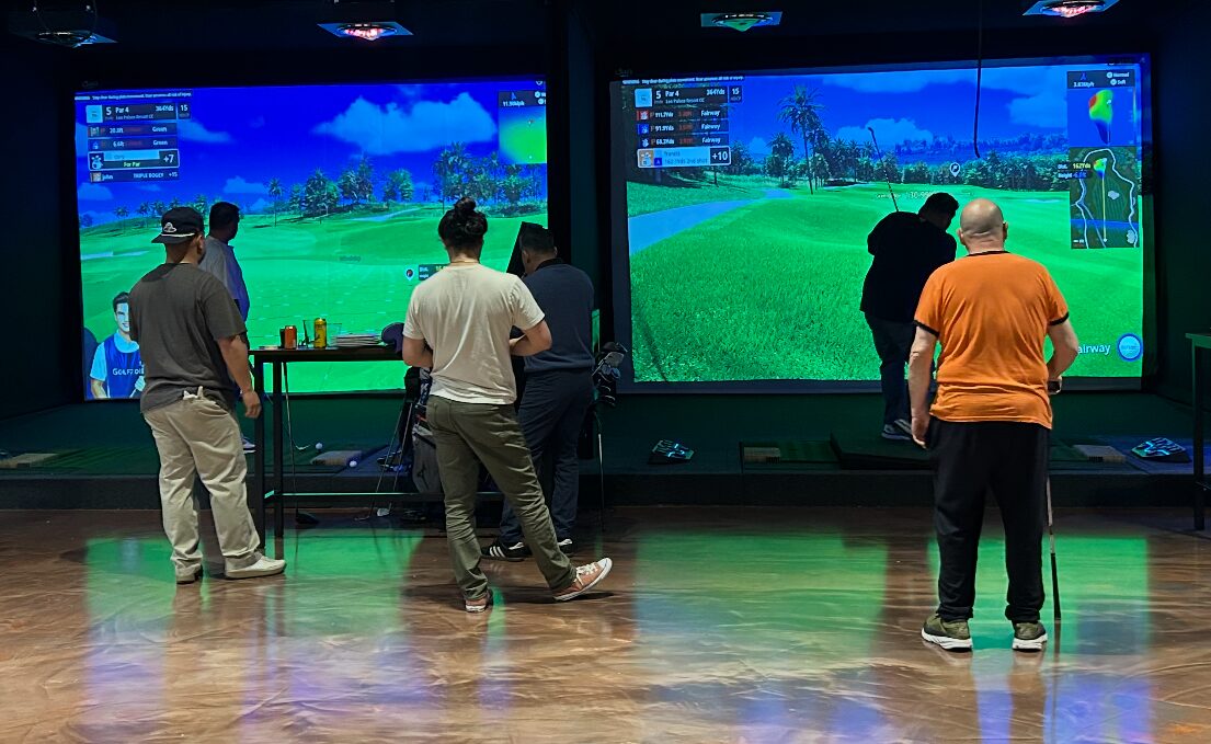 Golfers playing across the Pin Seeker simulator bays